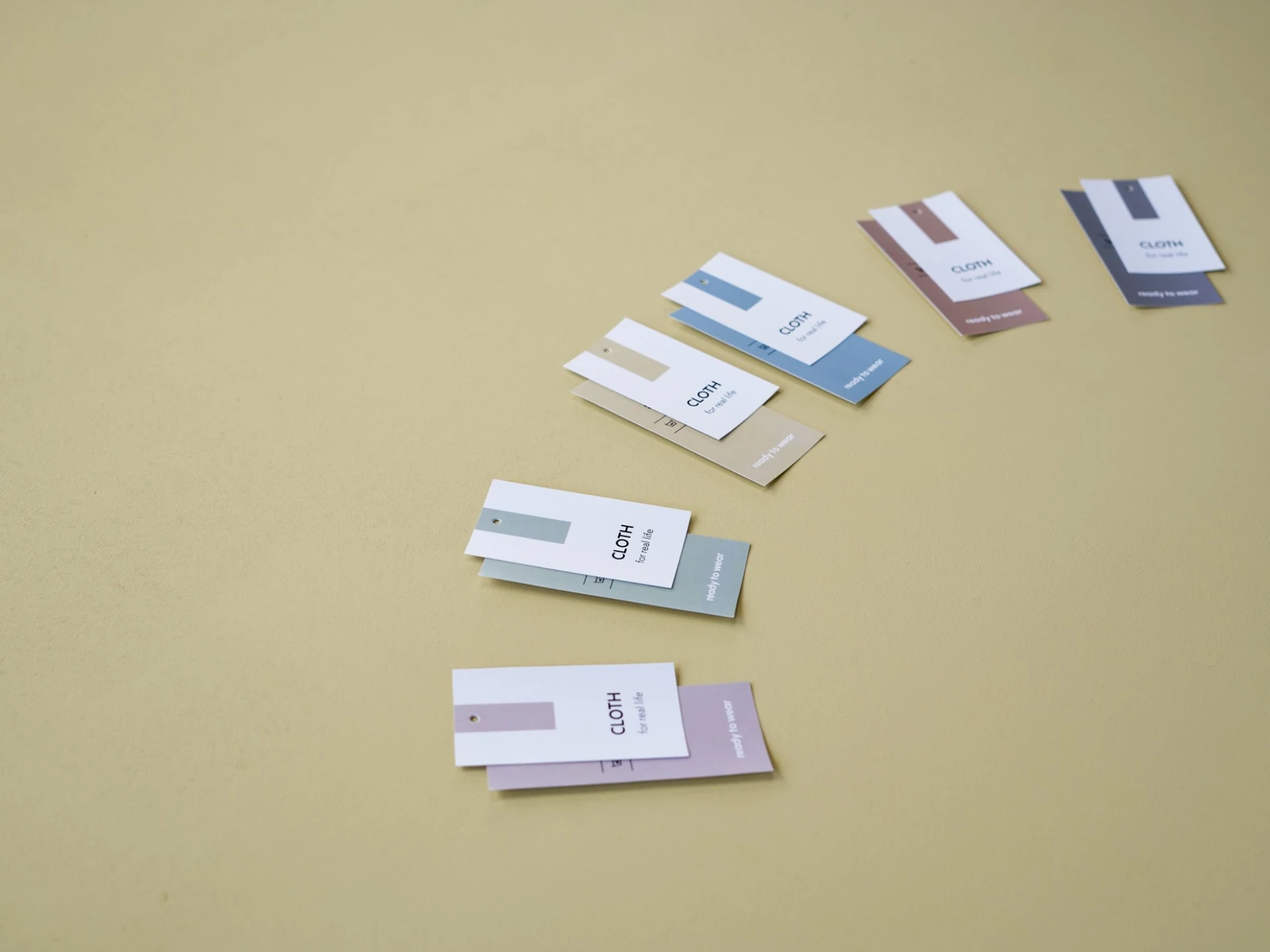 Printed clothing swing tags arranged on a neutral background